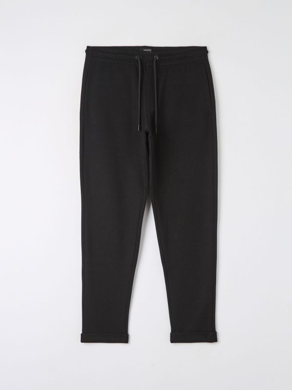 Plain jogger trousers in black pique fabric