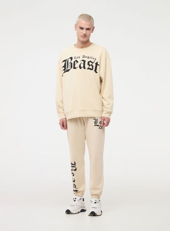 Joggers with gothic print beige